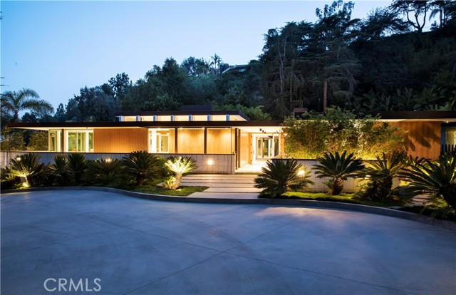 Designed by master architect, Rex Lotery, FAIA, in 1959 and situated in the iconic Trousdale Estates, this mid-century masterpiece has been meticulously restored. Sparing no expense, design team Philippe Naouri and Eric Choi of Maison d'Artiste, in collaboration with Studio Tim Campbell, have fully reimagined this architectural treasure. Conceptualised for French actress Corinne Calvet in the 1950s and inspired by a chance meeting with Charlotte Perriand, Rex Lotery pulled out every artistic stop in his design to honor and maintain mid-century minimalism. While he may never have imagined the modern luxuries that have been adapted to fill this artful space, he no doubt would approve of the current adaptation and precision which has insured the integrity of the original design for years to come. 8,800 sqft of residential indulgence sitting on over half an acre of manicured landscaping inspired by Brazilian modernism, this home leaves no need unmet. An abundance of amenities surrounds six bedrooms and eight bathrooms. A seamless kitchen, screening room, temperature-controlled wine enclave, and zero-edge pool are among the indulgences that steep the energy of this space with modern luxury. The Calvet Residence offers the best of both worlds, historic and modern, and lends a living experience unparalleled by contemporary design.