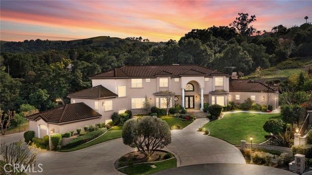 Spectacular Custom-Built Estate features beautiful city lights and hillside views! This over 6,200 square foot home features beautiful finishes throughout. The Gourmet kitchen features large kitchen island, granite countertops, 6 burner kitchenaid cooktop stove with pot filler, walk-in pantry, coffee/drink bar, breakfast nook and stainless-steel appliances which includes 2 dishwashers, warming drawer, double ovens, microwave and refrigerator. DOWNSTAIRS LARGE MASTER SUITE includes your custom built-in entertainment center, fireplace, custom walk-in closet with two separate entrances, beautiful master bath with spa tub, steam shower, double sink vanities, and linen storage. This home also features a DOWNSTAIRS Guest bedroom with attached bath. Upstairs includes 3-bedroom suites that include their own walk-in closet and full bathroom, bonus room with large window seat with storage, downstairs office and loft study space. This home also includes large gym/bonus room with bathroom, formal living room and formal dining room. This home is located on just under an acre (.9596), there is site parking for up to 20 cars, including the 3-car oversized garage. Additional features of the home include Commercial grade water softening R/O system, two water heaters and three zone A/C units. This backyard is built for entertaining! The backyard features large BBQ island with Viking BBQ which includes a rotisserie and side burner, large lawn space, sport court and patio area with outside fireplace. Not to mention the beautiful city lights & hill views! No Association and No Mello Roos. This property is STUNNING! All this privacy is a short distance to the 60 & 71 Fwy and to Orange County. This is one you wont want to miss!