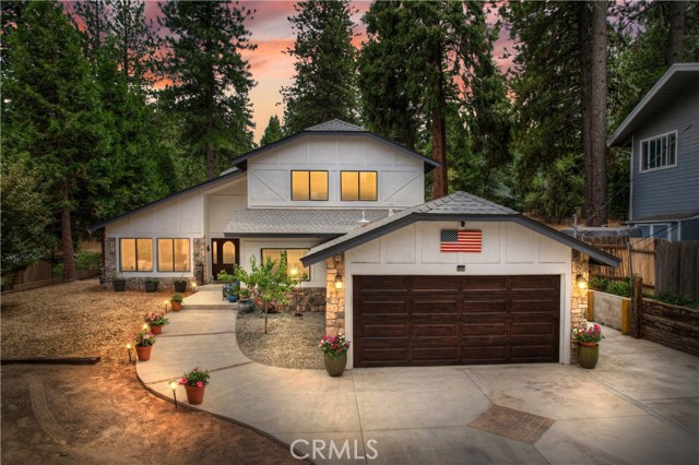 Gorgeous top of the line remodeled home with spacious attached ADU/separate living area on a large level wooded lot. Located in the popular Mile High Park neighborhood with the charming mountain town of Crestline and beautiful Lake Gregory nearby. This home is almost 2700 SQ FT plus 440 SQ FT over sized garage. Features a spacious open floorplan, cozy rustic fireplace in the den, dramatic vaulted ceilings in the main living room area plus amazing top of the line chef's kitchen with granite counters and stainless steel appliances. Upstairs includes a spacious master bedroom with en suite bathroom plus two more large bedrooms and another full bathroom. The separate living area/ADU features 1 bedroom, 1 full bath, kitchen, living room and a private concrete patio area with separate entrance. The single level separate living area/ADU features level entry as well for easy access. Large level front yard plus a huge new concrete patio in the rear for maximum outdoor entertainment space. Tons of parking with the large driveway, garage and additional side parking areas. This home has a very private feel with a large acreage forested area directly behind and big beautiful pines, cedars, and oaks all around. Current owners have put over $80,000 into recent upgrades including, new roof, new A/C, new high efficiency furnace, solar with battery backup, concrete patios, large storage shed and more. This is the ideal mountain dream home you've been waiting for...Make your offer today!
