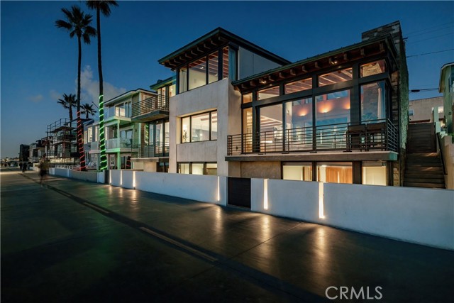 The best home in Hermosa Beach, close to the Hermosa and Manhattan Piers. An exceptionally rare opportunity to own a double lot with over 60' of ocean frontage on The Strand. Custom design by KAA Design Group and built by Baldwin, this luxury residence embodies the sand-and-surf California lifestyle through contemporary architecture. Each detail in the home is expertly designed to take advantage of the incredible views while allowing for privacy. As you enter through the front gate, you are greeted by a stunning private pool and spa, a turf yard, and an outdoor covered patio with sliding glass doors, BBQ, and an original wood-burning fireplace. The entry of the home sets the stage with immediate views of the Pacific Ocean, as well as a custom hanging light fixture that is emblematic of a ship navigation light. An inviting living room with high ceilings, a second wood-burning fireplace, floor-to-ceiling sliding glass doors that lead out to your private deck overlooking Hermosa's finest volleyball courts and, of course, the ocean and sand. Seamlessly continuing from the living room is the dining room, a built-in bar, and a chef's kitchen featuring an island with bar seating, a breakfast nook with an additional outdoor deck, a Wolf stainless-steel range, and a dual SubZero freezer-refrigerator. The upper level of the home consists of 3 suites with a full bathroom, a laundry room, and the perfect primary suite, equipped with a luxurious bathroom with a soaking tub and large walk-in shower, a private deck, an over-sized walk-in-closet, and endless views of the water. The basement level continues the beach living lifestyle with a massive entertaining space featuring a daybed, 670-bottle wine cellar, secondary kitchenette, and sliding glass doors leading out to your private, sunken patio. An additional guest bedroom, an office or 6th bedroom, and a spa-like bathroom with a steam shower complete this floor. Other notable features include a copper roof, outdoor shower, 2-car garage with room for 2 more cars, a separate utility room for your house and pool equipment. Throughout this residence, the highest-grade stones, tiles, woods, and fixtures are used to create lasting structural integrity and to protect the home from the common wear-and-tear of living on the beach. Just as the navigation light suggests when you enter 3301 The Strand, let it guide you to a once-in-a-lifetime oceanfront opportunity at Southern California's best beach community.
