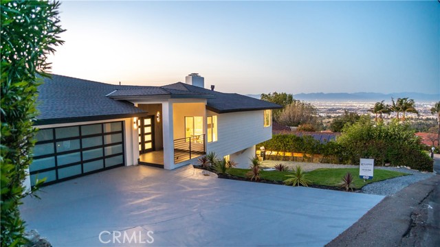 This completely remodeled 4 bedroom, 3 1/2 bath home is an entertainer's utopia, nestled in the prestigious Westfield Neighborhood of the Palos Verdes Peninsula on three-quarters of an acre. This warm and sleek contemporary home offers two levels of expansive city light views, a sprawling two-tiered yard with an abundance of mature landscaping, and a flexible floor plan with three separate gathering spaces. The well-appointed kitchen features gleaming quartz slab countertops with an impressive counter to ceiling matching backsplash, Thermador appliances, and for additional convenience, a pot filler over the 6 burner range. Down the hall you ll find the 3-car garage with epoxy flooring, a guest bath, and two bedrooms, one being the spacious primary bedroom with more views of the city and access to the garden. Retreat into the luxurious bathroom which offers a rain shower, free-standing tub, double vanity sink, and is accented with gorgeous floor to ceiling designer tile. The final gathering space is found downstairs along with two more bedrooms and a full bathroom. The private and serene yard with multiple patios is the ideal setting for small or large entertaining. The home also features new electrical and plumbing, a new roof, heating, and air conditioning.
