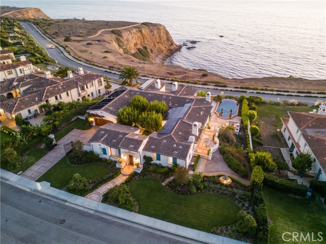 The only bluff front property with coveted white water views in the exclusive Oceanfront Estates community! Regardless of your route to this sprawling French-inspired estate, you will notice you have arrived at the highest point on Via Del Cielo. This home sits at the center of Golden Cove Beach. Enter this privately gated estate through the central courtyard, where you are transported to a tranquil paradise listening to the sounds of the babbling fountain. As you pass the enchanting red bark trees that escort you to the main entrance, you're welcomed by the methodical sounds of the Pacific Ocean. You might not want to leave the central balcony that drew you over to the showstopping coastline views, but this house has so much more to offer! The chef's kitchen is fully equipped with a large walk-in pantry, Viking range top, oven, and newly replaced appliances, including a Sub-Zero refrigerator, Miele Speed Oven, built-in Miele Coffee System, Miele warming drawer, and Bosch double dishwashers. An outdoor kitchen is adjacent to the saltwater pool, that, in addition to the spa, can be heated by the solar hot water system. The estate is powered by a 9.1kw solar power system, wired with CAT6, and equipped with a camera security monitoring system. The floor plan affords the perfect balance of privacy and play. Two ensuite bedrooms grace the main level. One with has breathtaking ocean views that can be an inspiring home office; and the other a private guest casita adjacent to the relaxing loggia with an outdoor fireplace. The additional four bedrooms are on the second level. The primary suite occupies the left wing with an oversized closet and ensuite bathroom with views from the soaking tub. On the same level, is the game room with a full wet bar, a 400+ bottle temperature-controlled wine cellar, and three additional ensuite bedrooms, one of which makes for a perfect home gym or theater room. A laundry room on each floor provides modern convenience. The four-car garage provides capacity for the pickiest of collectors. If an elevator is desired, the home is situated for future installation. Oceanfront Estates community is a 24/7 guarded community with license plate reader monitoring and only twenty-three bluff front lots. This rare property is available for the first time!