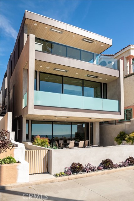 Welcome to one of the most unique, quality designed and built Strand homes in Manhattan Beach. This Mid-Century beach modern home is perfect for family fun with 180 degree ocean views from Palos Verdes to Malibu. Let's start with the largest outdoor patio on the entire Strand boardwalk... at 714 square feet (300 square feet is covered) you'll be entertaining family and friends. 1st floor living has an open floor plan featuring floor to ceiling sliding Fleetwood glass doors the width of the property. The kitchen is spacious with a large stone waterfall island ideal for food prep and dining. Amenities include a large walk-in pantry, and top of the line Miele appliances featuring oven with warming drawers, microwave and extra large refrigerator. There's more fun waiting downstairs (use the three-story elevator for convenience). Basement features a theater room with built-in speakers and carpet flooring providing ideal acoustics for all your audio and video entertainment. Adjacent is a flex room which can be a playroom for kids or an area to set up the gym equipment. The entire recreation area is attractively paneled with floor to ceiling Oak Wood Veneer to keep noise to a minimum. The large laundry room with built-in upper and lower cabinets and sink is located conveniently near the elevator. Now it is time to luxuriate in your Master Bedroom on the second floor. Again, the stunning, unobstructed ocean views are yours to enjoy from the moment you wake up thanks to floor to ceiling sliding Fleetwood doors. A beautiful, fully appointed bathroom has a bathtub overlooking the ocean, a large glass shower, wall mounted toilet and a wide double sink counter. Other amenities include: Oak wood veneer floor to ceiling paneling, white oak flooring, recessed lighting in all rooms, multi-zoned A/C, tankless water heaters and 2 car garage parking with one additional spot for guests.