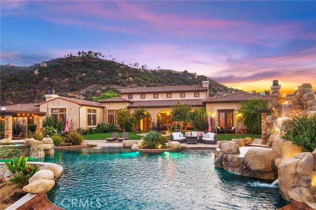 *** SEE THE VIRTUAL TOUR ***Welcome to this stunning single story Tuscan inspired estate with some of the most amazing views in La Cresta! As you approach the home you are met by gorgeous double wrought iron custom doors and enter into a grand room with approximately 22 foot ceilings, a striking fireplace, french doors for direct backyard access, stunning views, and full bar complete with sink anD wine fridge and distressed hardwood flooring throughout. The formal dining room is adjacent to the formal living room and is currently being used as a game room. The kitchen is perfect for entertaining with a built in GE Monogram refrigerator & freezer, two dishwashers, double oven, 6 burner Viking stove, hood, prep sink, built in microwave, and oversized walk in pantry. The kitchen opens to the family room with a fireplace and an additional eating area with backyard access. There is an office with a beautiful built in, media closet, and is currently used as a theatre. The master bedroom has beautiful coffered ceilings and french door access to the backyard with a quaint sitting area. The master bath is gracious in size and decor with an enormous shower with dual shower heads, his & her walk-in closets and toilets. There are four secondary bedroom ensuites that all have walk in closets. As you enter the backyard you are met by the covered veranda which looks out at the breathtaking views. Nothing was spared in this backyard from the gorgeous pebble tech pool with waterfall, slide, grotto, spa, and two infinity edges which showcase the views of this home perfectly. There are also water fountains, outdoor kitchen complete with sink, refrigerator, bbq, burner and TV hookups, orchard with approximately 30+ fruit trees, garden area, beautiful outdoor fireplace, multiple arbors and sitting areas to enjoy every angle of this homes stunning surrounding views! You will also find an outdoor shower with access to a bathroom which features a toilet and sink. Did I mention 70 owned solar panels and no electric bill? This home is located close to horse trails and has space for a barn if your looking to bring your horses. You don't want to miss this breathtaking home!