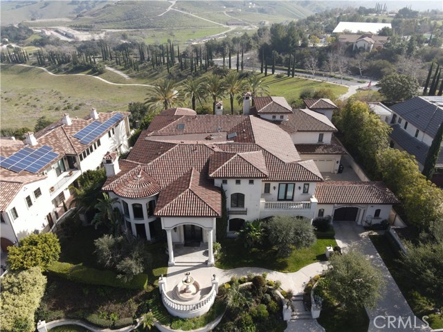 Nestled in the exclusive 24-hour gated Vellano community, this custom estate is adorned with a spacious design complemented by its lofty ceilings and alluring architectural detail. This 10,397 sq ft estate is situated on a 23,542 sq ft and offers 5 bedroom, 7 bath, and 4 car garage with stunning views overlooking the natural beauty of the surrounding canyon, juxtaposed with the city s night light skyline. Perfect for welcoming guests, it boasts a home theater, a game room, and an outdoor entertaining area highlighting a swimming pool, spa, and grilling area. The grand and expansive foyer serves as the entryway for the main level which features a professionally outfitted kitchen equipped with top quality appliances, a step-down wine cellar, a home gym with full wall mirror, and an extensive office space. Two staircases and a private elevator provide passage to the upper level which features a master suite with a custom walk-in closet and a spa inspired master bathroom in addition to 3 bedroom suites each with respective retreats of an elevated loft, an office/library, and a step-up window nook.