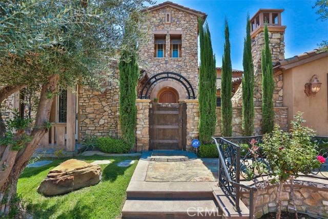 This stunning Tuscany-style estate located in the exclusive gated  Vellano  Community is an exquisite private residence of masterful art deco and European architectural styles. A Tuscany custom wrought iron fence opens to a beautiful center courtyard with a trickling fountain and fireplace. This 5754 sqft estate offers 5 bedrooms, 5.25 baths. Upon entering there is a gorgeous high ceiling foyer with a custom inlay medallion. This stunning home has been updated with a fresh interior paint and all 5 bathrooms are tastefully renovated. Throughout the entire house, there is granite and handmade hardwood flooring along with luxurious craftsmanship and built-in handcraft cabinets. Gourmet Kitchen upgraded with quartz countertop and backsplash which features a double Center Island, top-of-the-line appliances including built-in oversize refrigerator, double ovens, double warmer, two dishwashers, and two 48 inches Beverage Chiller. The spacious master suite on the first floor features a large folding door overlooking the beautiful nature and canyon views. The luxury master bathroom offers double sinks, a modern Freestanding bathtub, upgraded plumbing fixture, and a walking closet. Generous space is offered in all other bedroom suites. The lush grounds include Koi Pond, golf putting green for grand entertaining, and a great capacity Barbecue Pavilion with a fully equipped outdoor kitchen. The spacious pool house can be used as an entertainment place for billiards and poker. The backyard contains over twenty different kinds of exotic fruit trees and has a panoramic view of the mountain and city lights. The flawless floor plan and all exquisite detailing give this estate a dramatic appeal that any buyer would appreciate.
